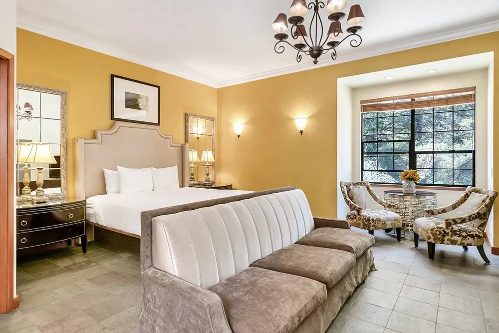 A king bedroom at Sonoma Coast Villa with cream walls and a vaulted beamed ceiling