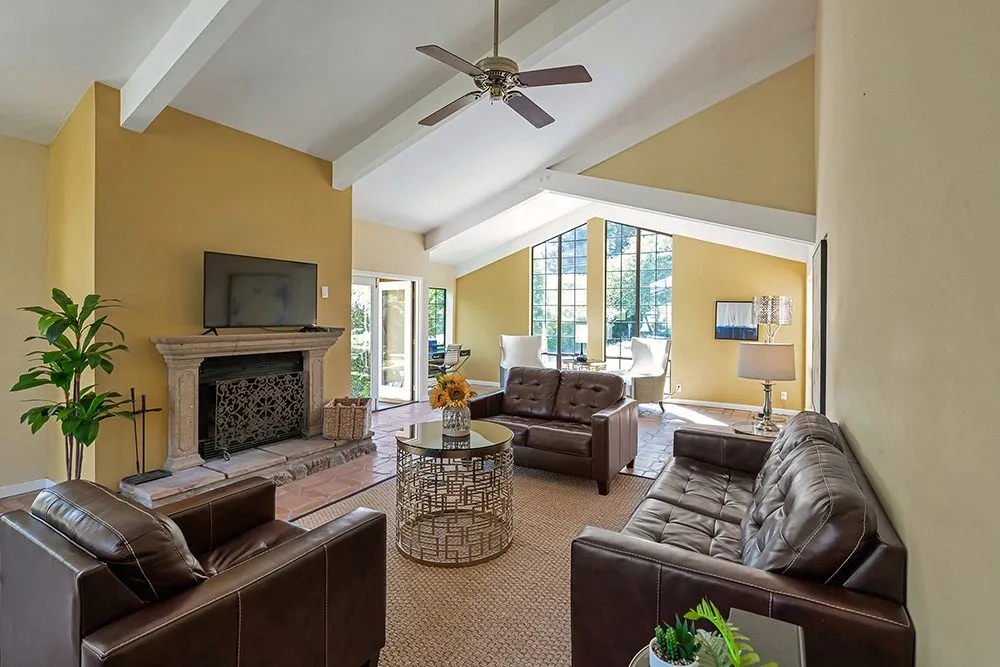 The living area of a suite, with a fireplace and leather seating
